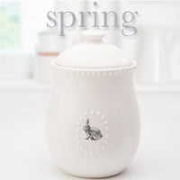 White Ceramic Canister w/Lid and  5 Interchangeable Metal Seasonal/Decor Magnets.